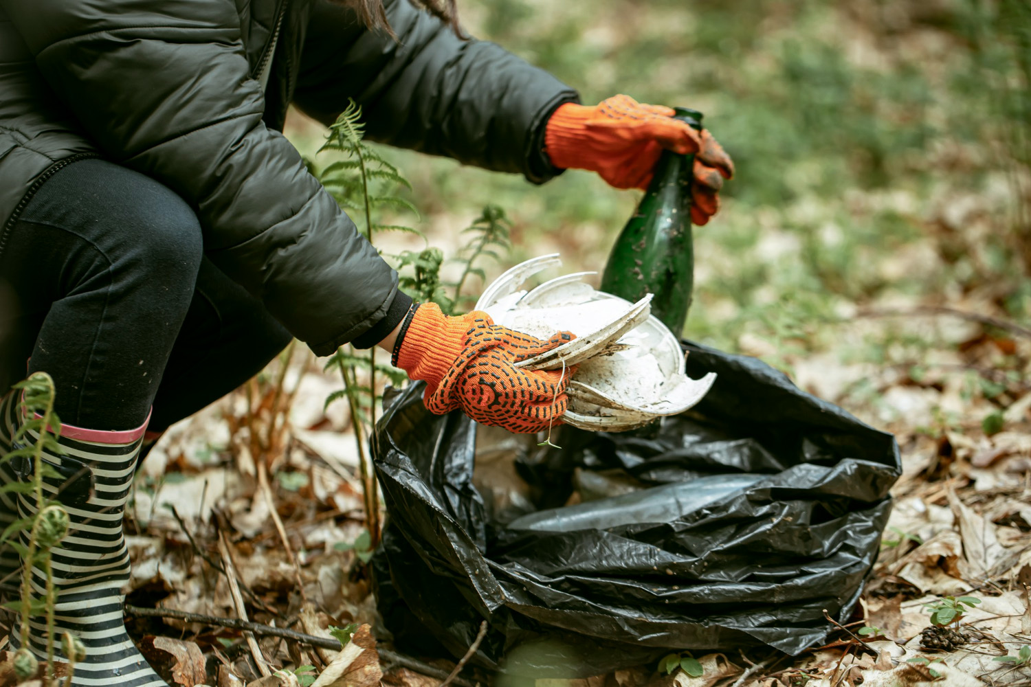 Cleaning up trash inside of the woods.